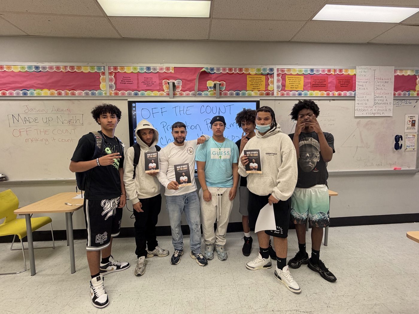 Students holding copies of Off The Count after a session