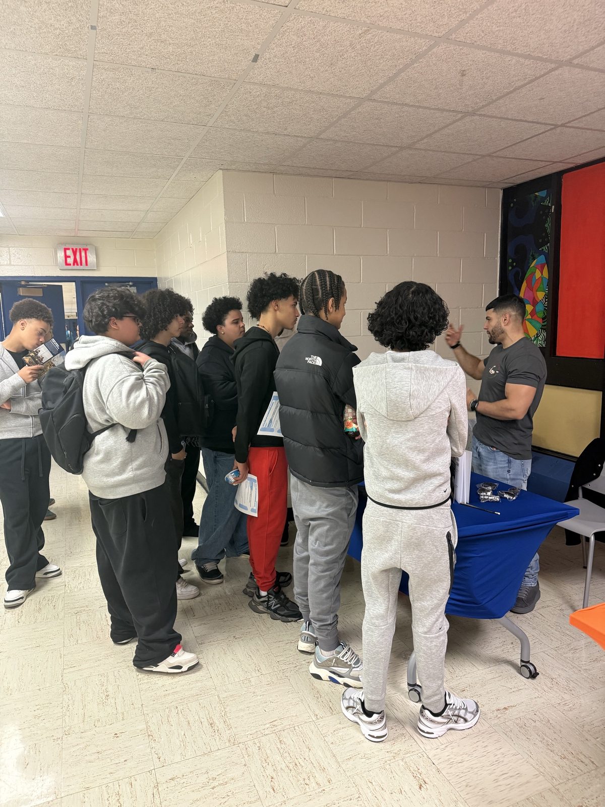 Students lining up to speak with Jason after a school session
